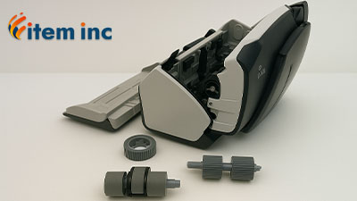 Fujitsu scanner with replacement roller kit components displayed in front, including pickup and feed rollers, with Item Inc. logo in the corner