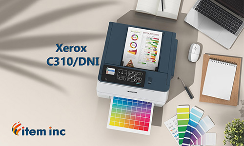 Top-down view of a modern desk: a Xerox C310/DNI color laser printer is printing a vivid CMYK chart; nearby are a laptop, mouse, notebook, color swatch card, small potted plant, and branding text reading “Xerox C310/DNI” and “item inc.”