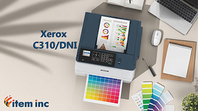 Top-down view of a modern desk: a Xerox C310/DNI color laser printer is printing a vivid CMYK chart; nearby are a laptop, mouse, notebook, color swatch card, small potted plant, and branding text reading “Xerox C310/DNI” and “item inc.”